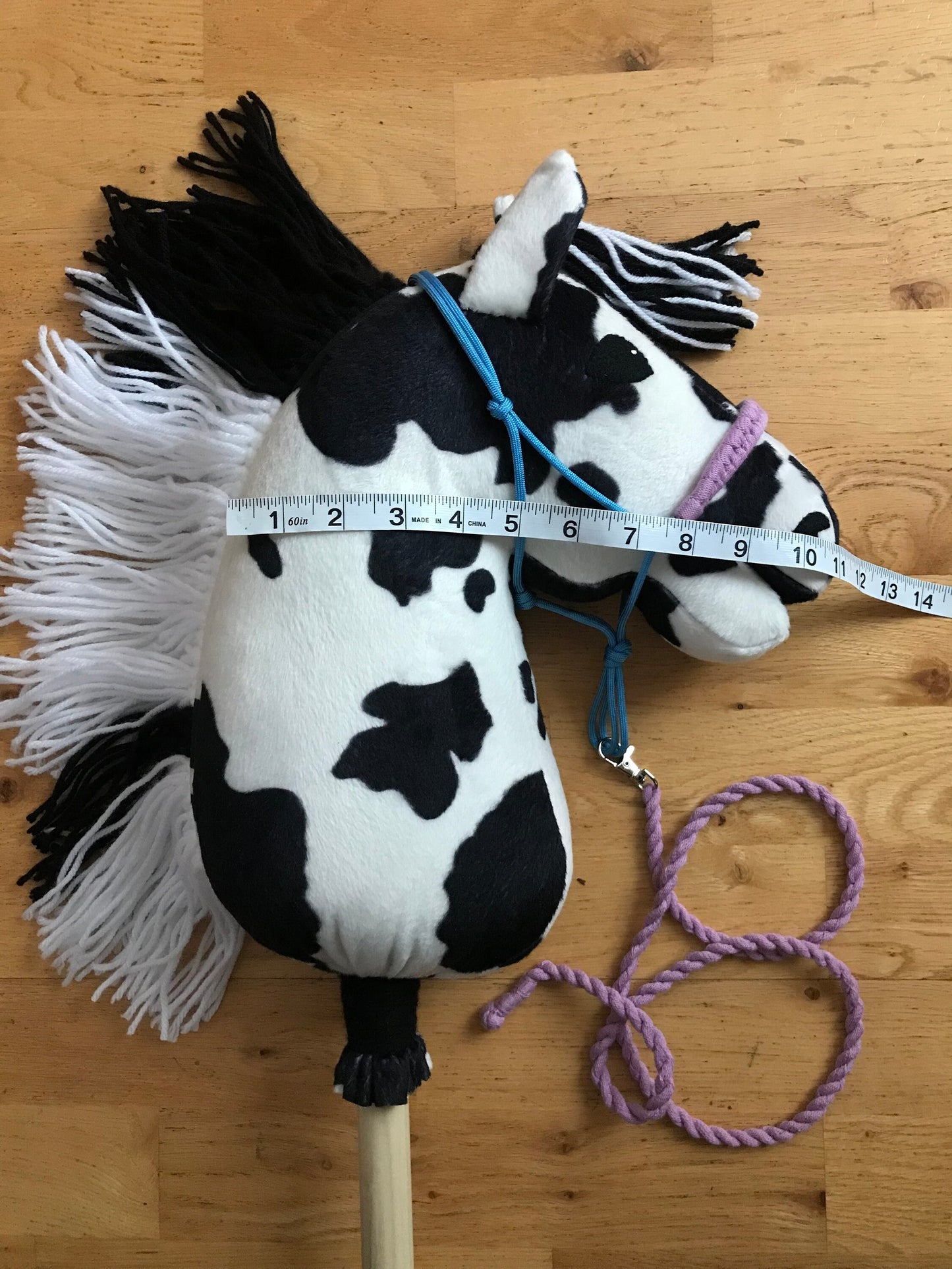 Hobby horse on a floor, close up picture of the head, Measuring tape measuring horses head 11"