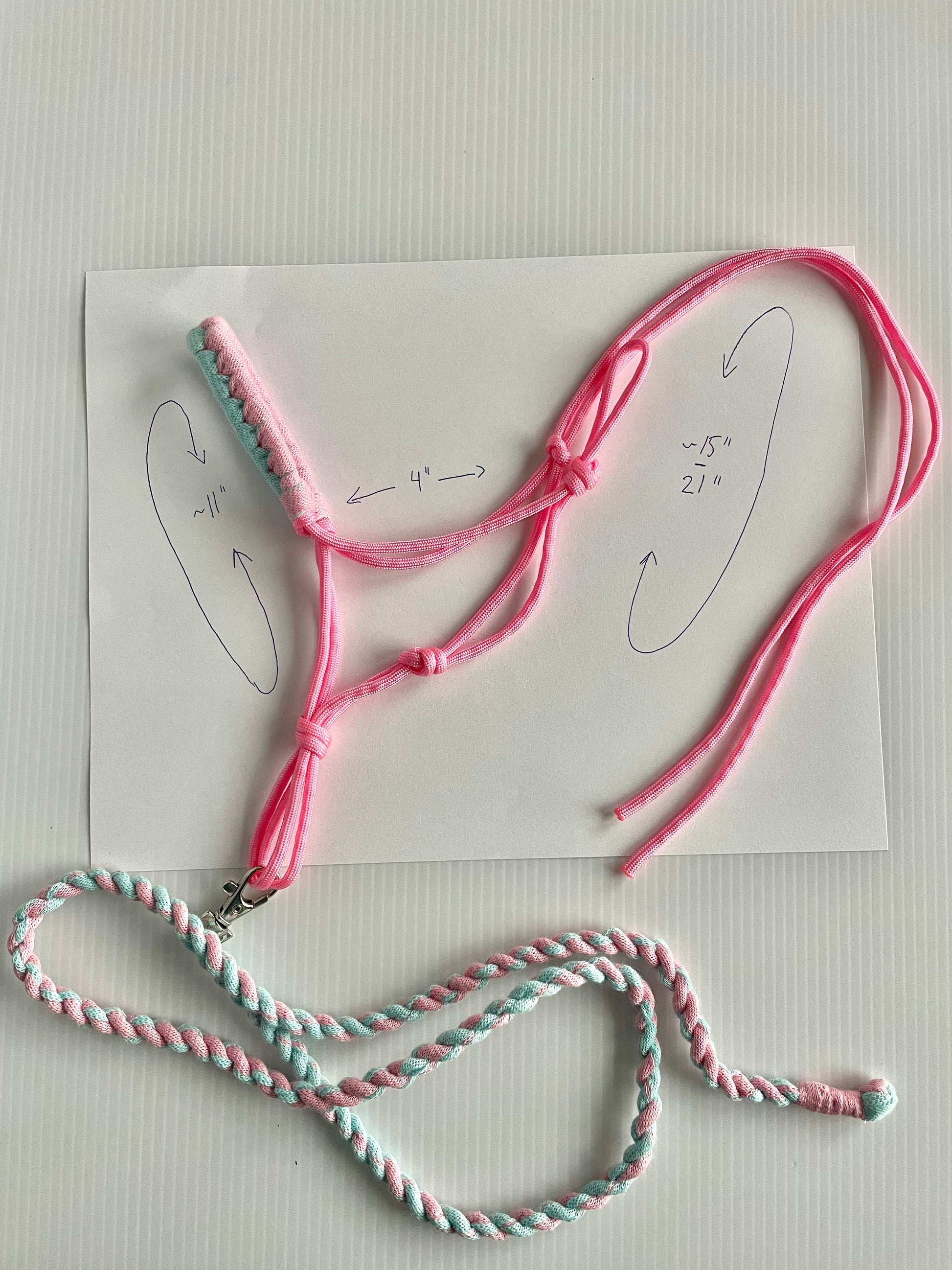 Hobby horse halter pink and a lead rope that is pink and turquoise on a white background. Showing measurements.