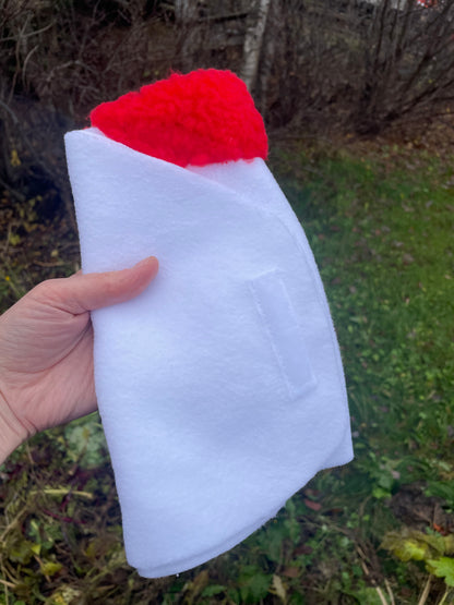 White hobby horse blanket with a red padding on  a natural background