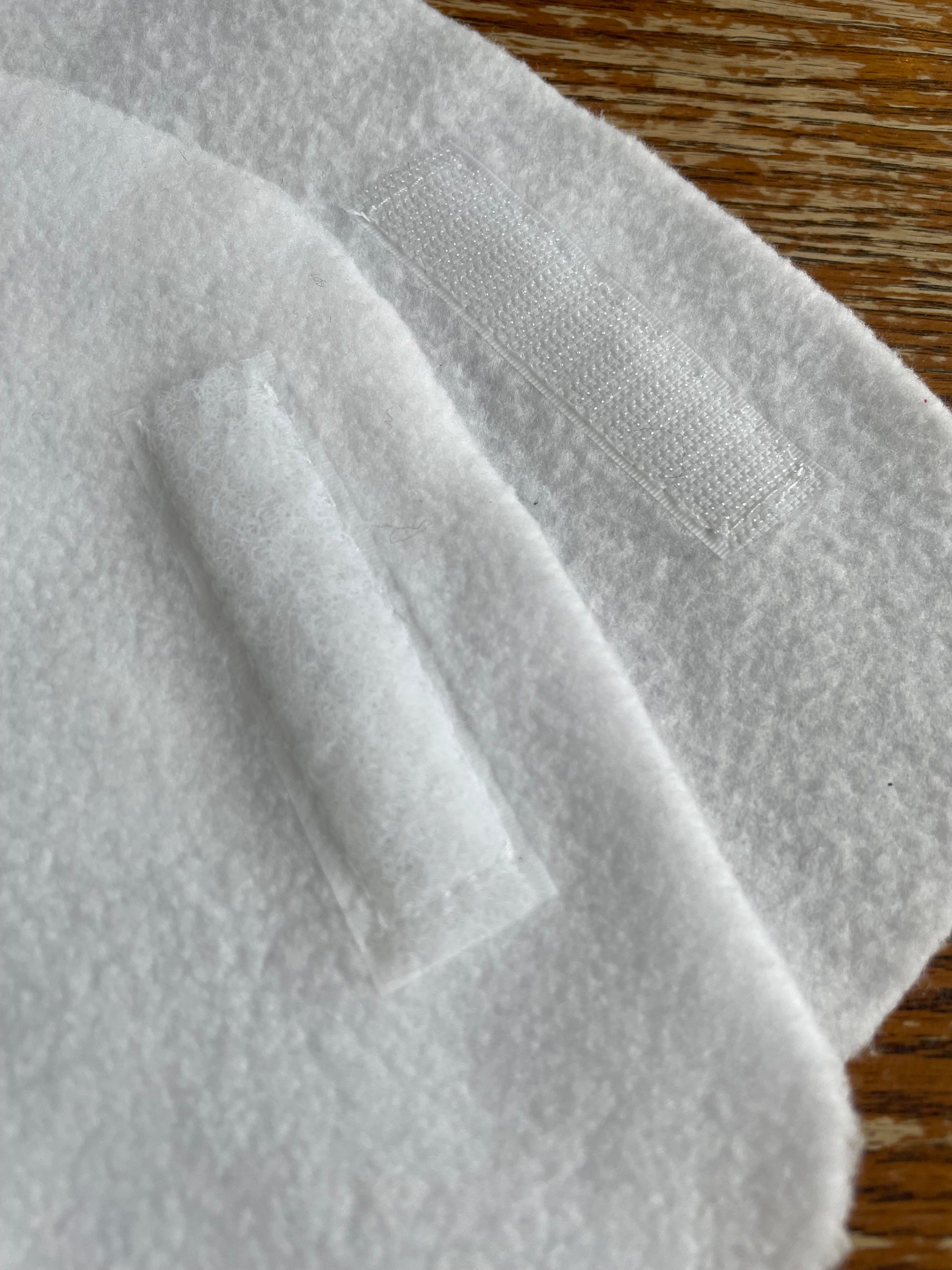 Close-up of white hobby horse blanket on a wooden background