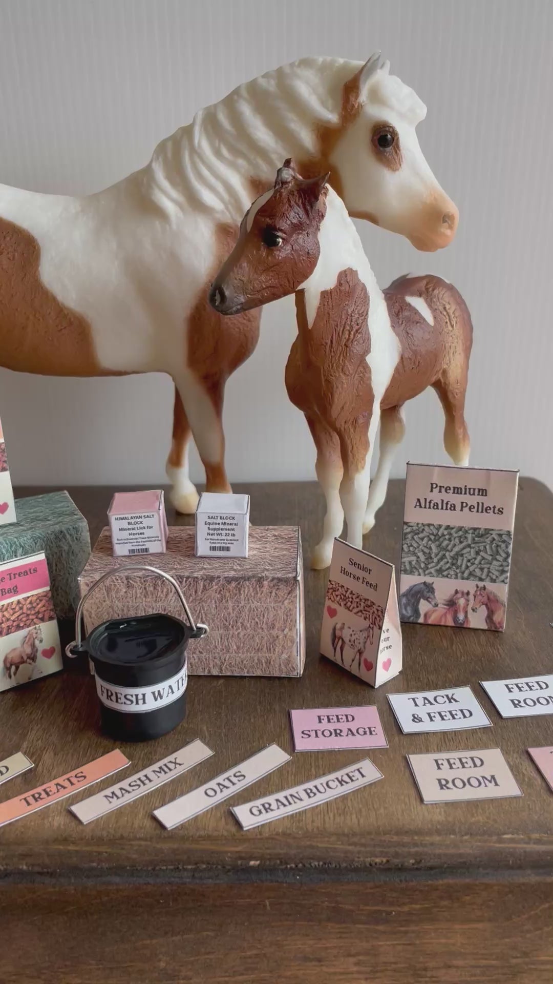 Miniature horse feed packs on the front, 2 model horses on the background